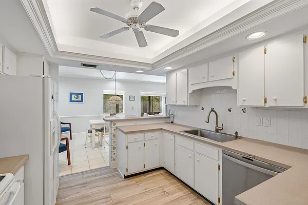 a kitchen with a sink cabinets and wooden floor