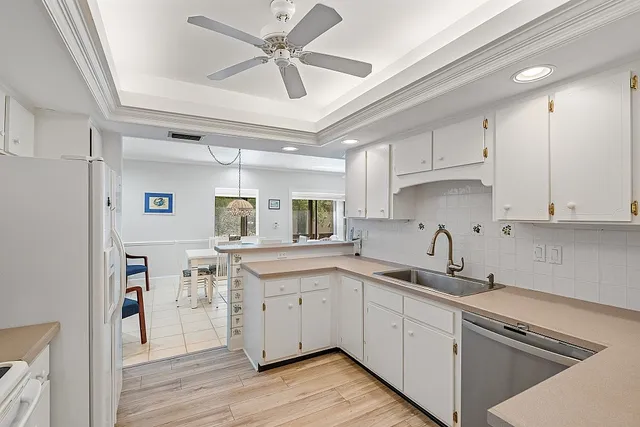 a kitchen with a sink cabinets and wooden floor