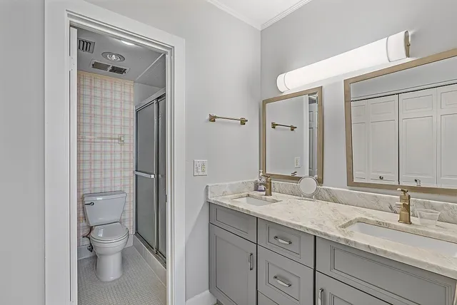 a bathroom with a granite countertop sink toilet and shower