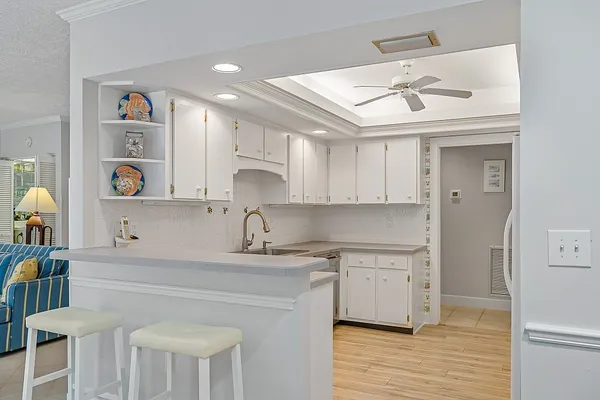a kitchen with a sink cabinets and wooden floor