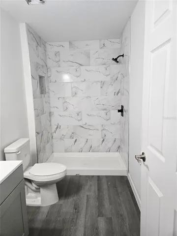 a bathroom with a toilet and a shower