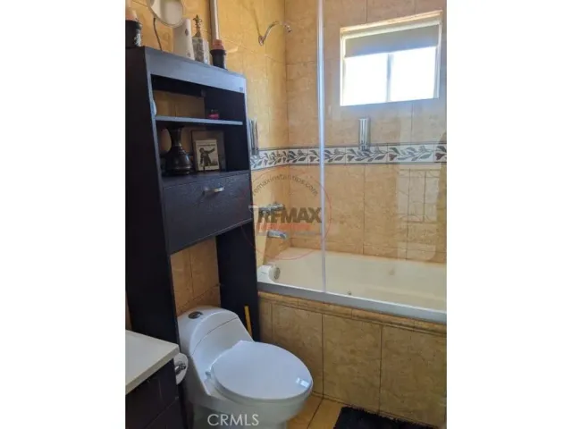 a bedroom with a bed and cabinet