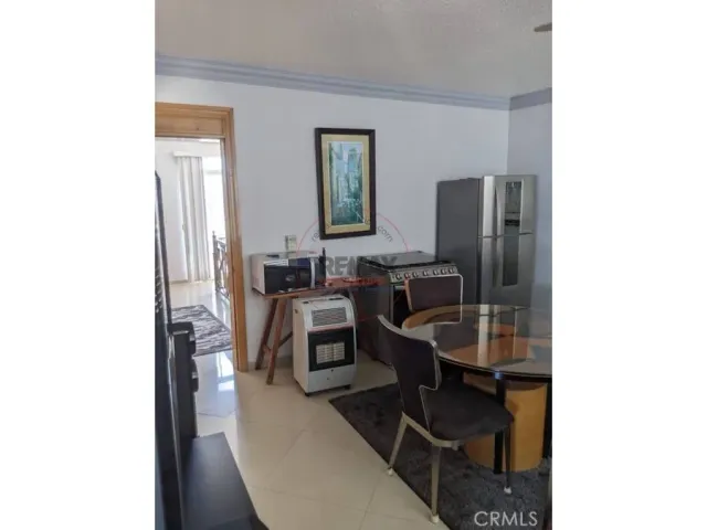 a roof deck with table and chairs couches with wooden floor