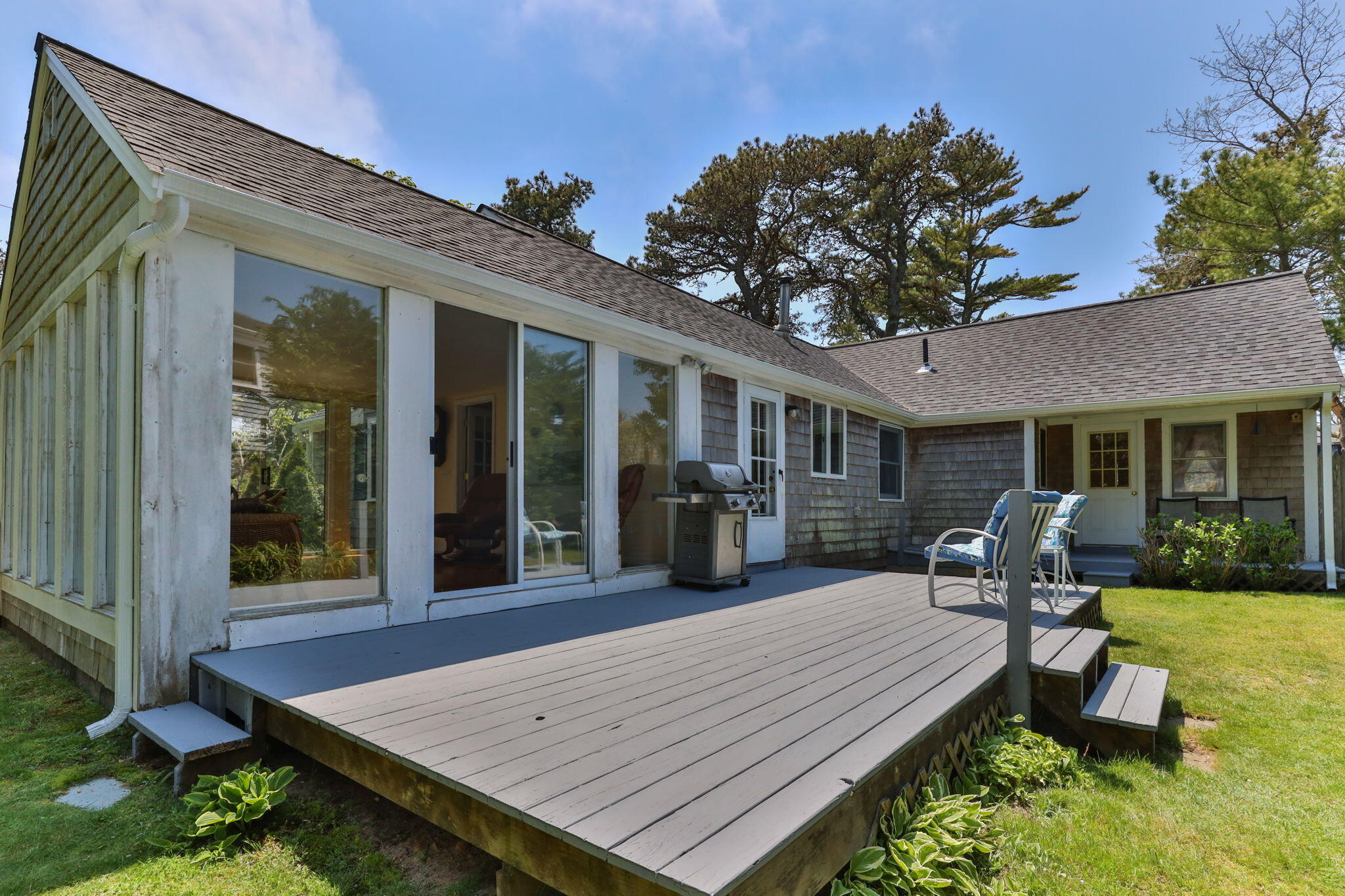 7 Aunt Matties Road Chatham, MA 02633 - Photo 31 of 37 a view of a patio with table and chairs with wooden floor and fence