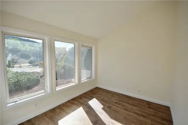 a view of wooden floor and brick walls
