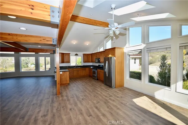 a view of a kitchen with a sink and a refrigerator