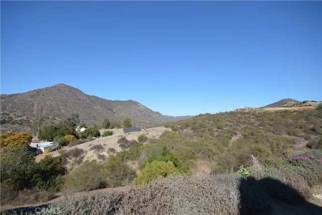 a view of a mountain range with trees in the background