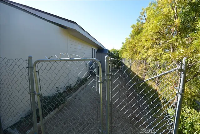 a front view of a house with yard and parking