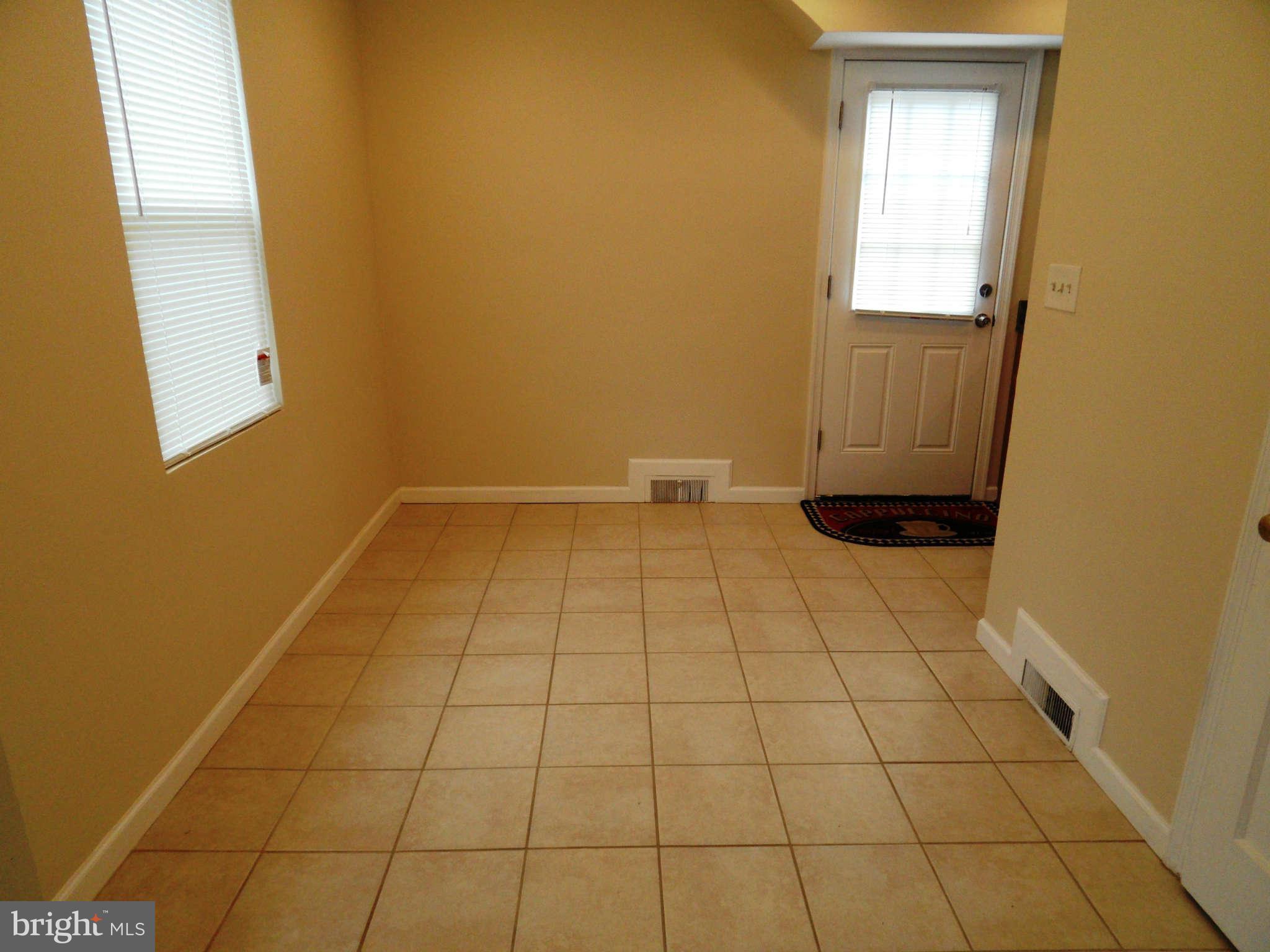 7019 Brompton Road Baltimore, MD 21207 - Photo 4 of 26 a view of empty room with windows