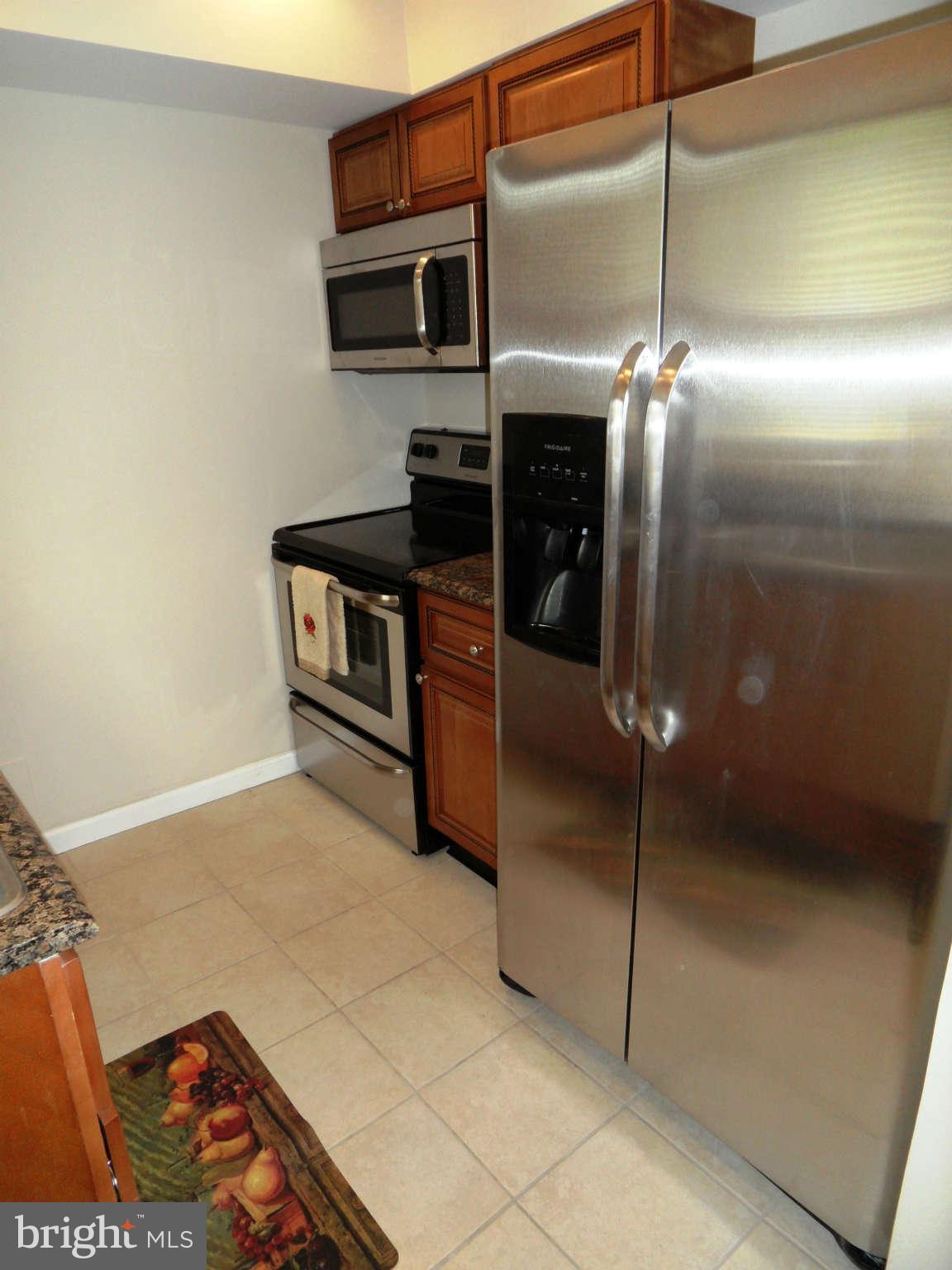7019 Brompton Road Baltimore, MD 21207 - Photo 8 of 26 a kitchen with stainless steel appliances a refrigerator and a stove