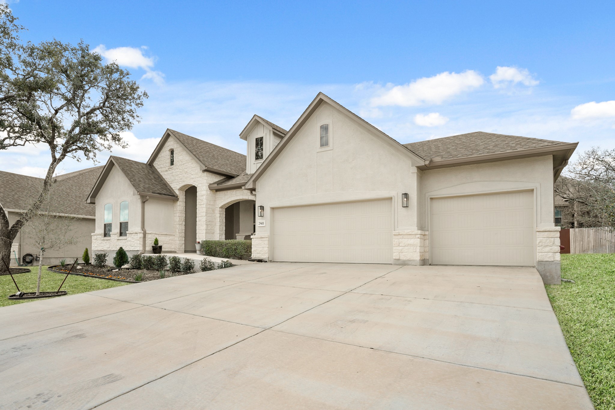 29411 Kearney Ridge Boerne, TX 78015 - Photo 26 of 34 a front view of a house with a yard and garage
