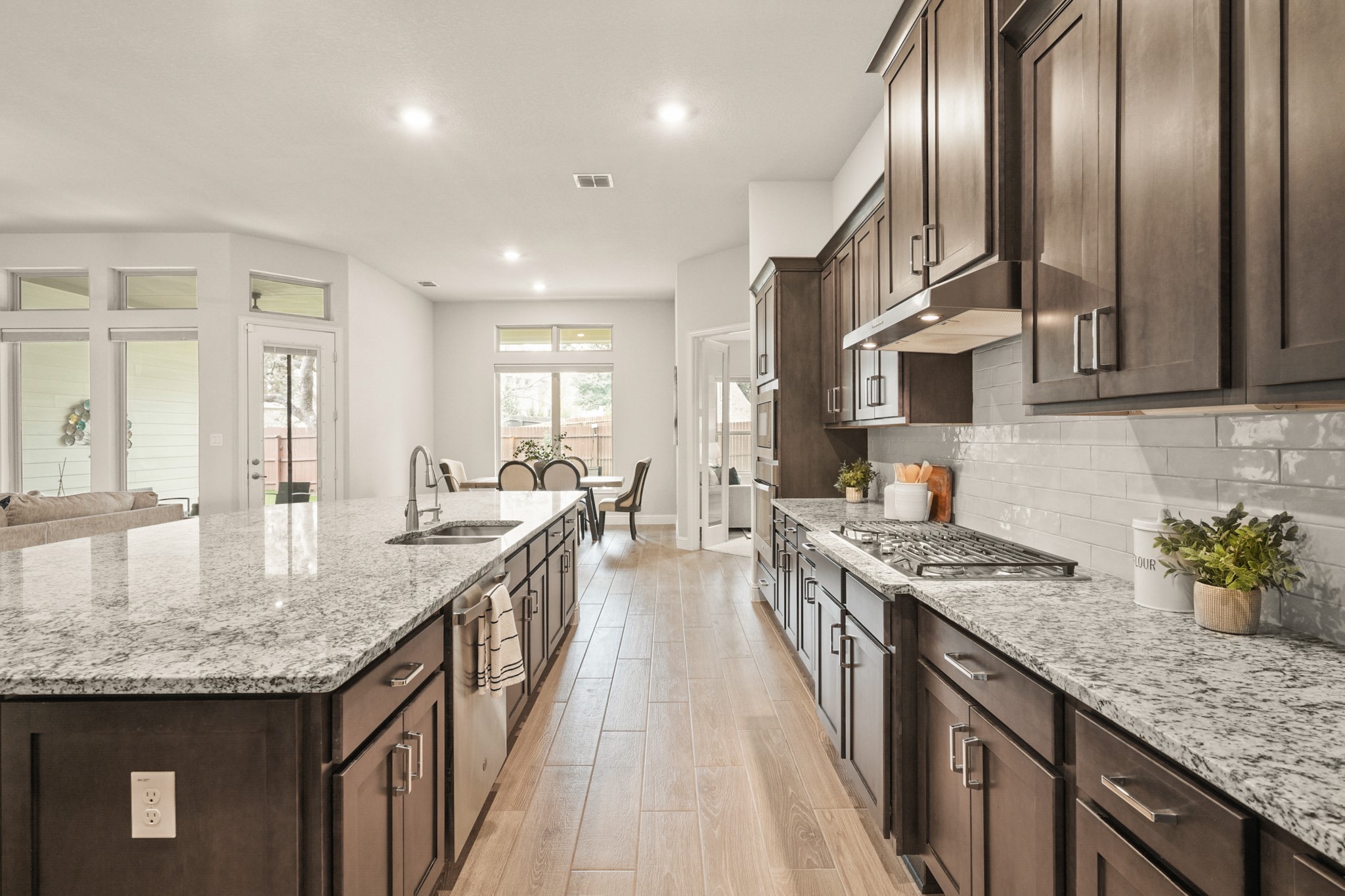 29411 Kearney Ridge Boerne, TX 78015 - Photo 5 of 34 a kitchen with stainless steel appliances granite countertop a sink a stove and a wooden floors