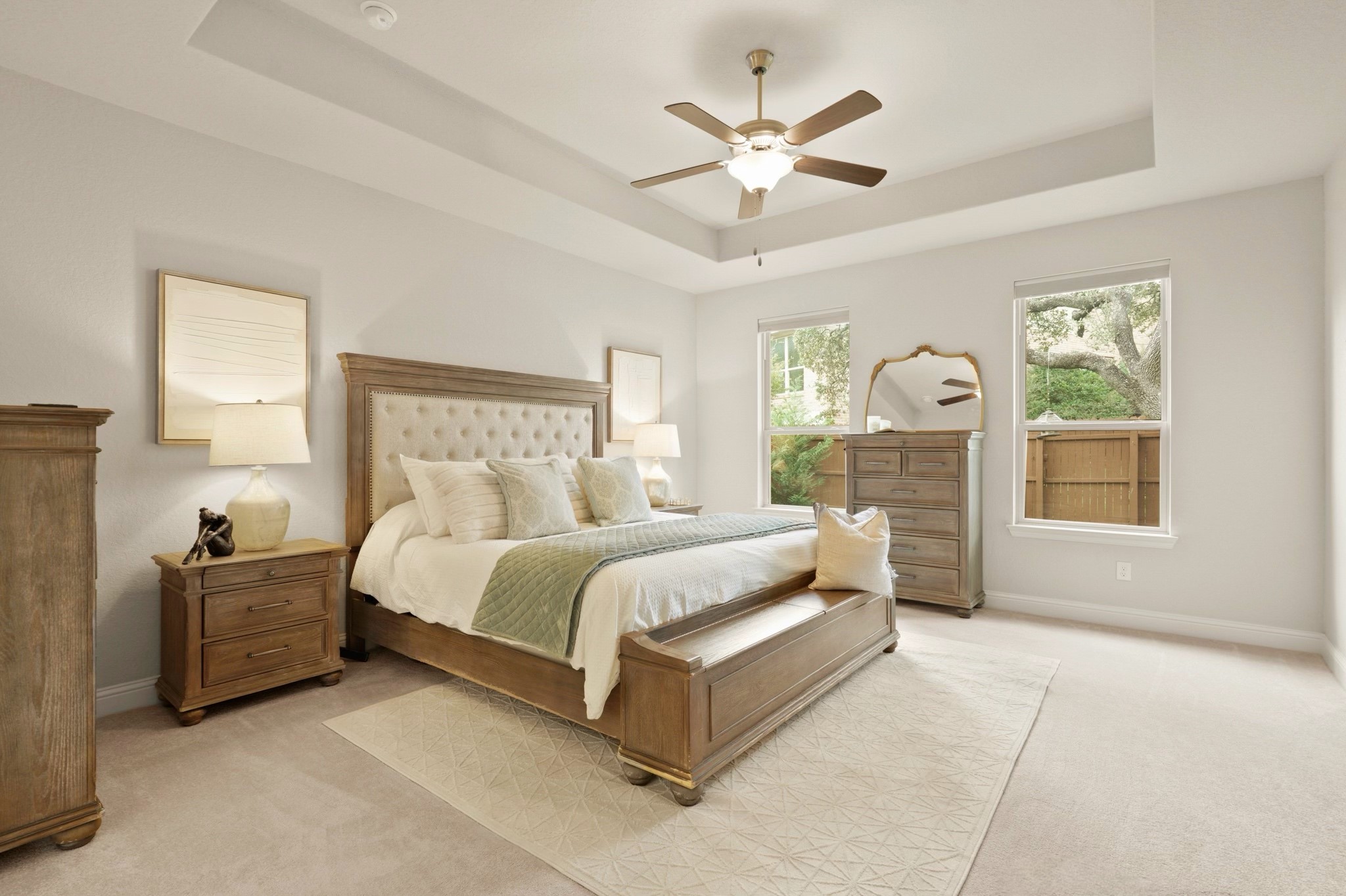 29411 Kearney Ridge Boerne, TX 78015 - Photo 6 of 34 a spacious bedroom with a large bed a chandelier and windows