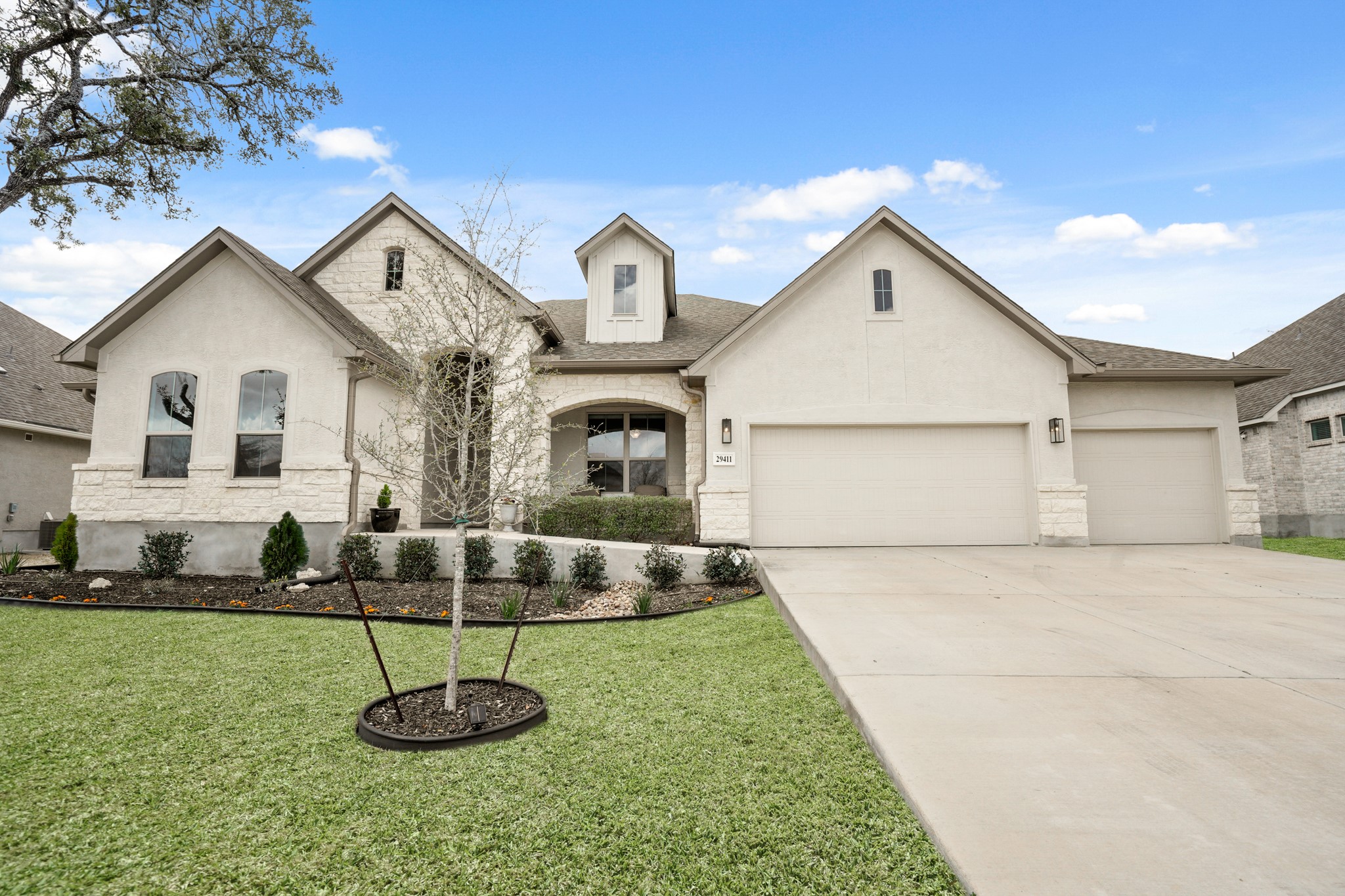 29411 Kearney Ridge Boerne, TX 78015 - Photo 10 of 34 a front view of a house with a yard and garage