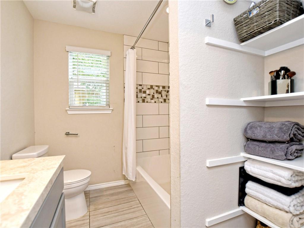 504 West 2nd Street Elgin, TX 78621 - Photo 11 of 22 a bathroom with a sink a toilet and shower