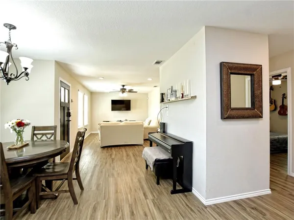 a living room with furniture and a wooden floor