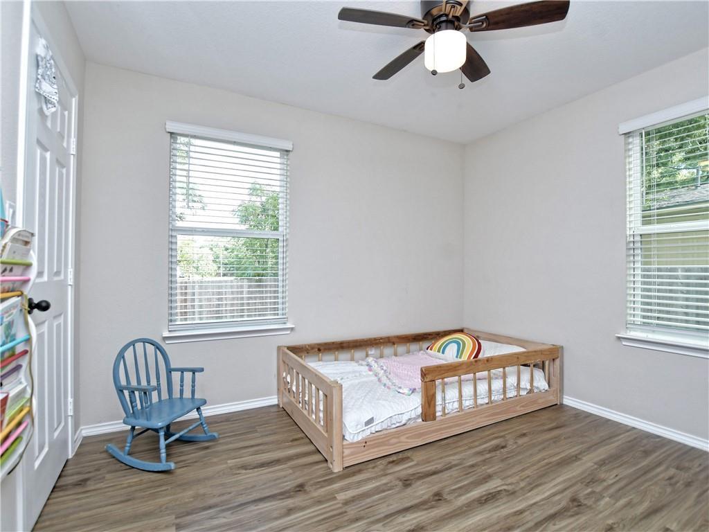 504 West 2nd Street Elgin, TX 78621 - Photo 18 of 22 a bedroom with a bed and wooden floor