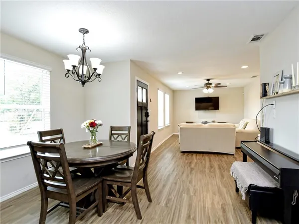 a living room with dining room and kitchen view