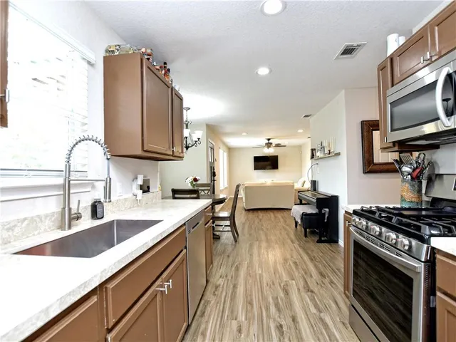a kitchen with a sink stove and microwave
