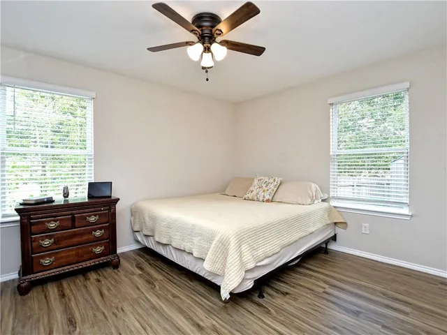 a bedroom with a bed dresser and a window
