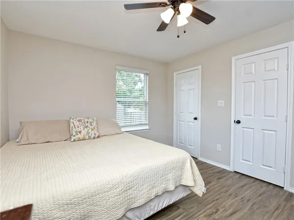 a bedroom with a large bed and a chandelier