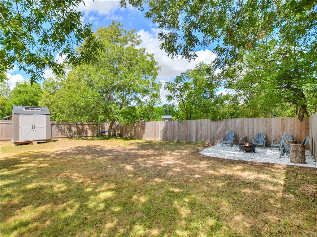 504 West 2nd Street Elgin, TX 78621 - Photo 10 of 22 a backyard of a house with table and chairs and wooden fence