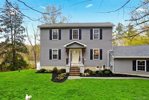 a front view of a house with a garden