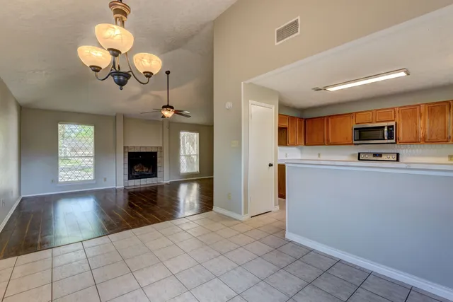 a view of a kitchen center island wooden floor and living room