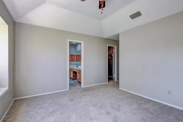 an empty room with closet and a window