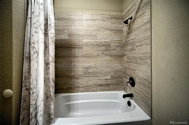 a bathroom with a tub and shower