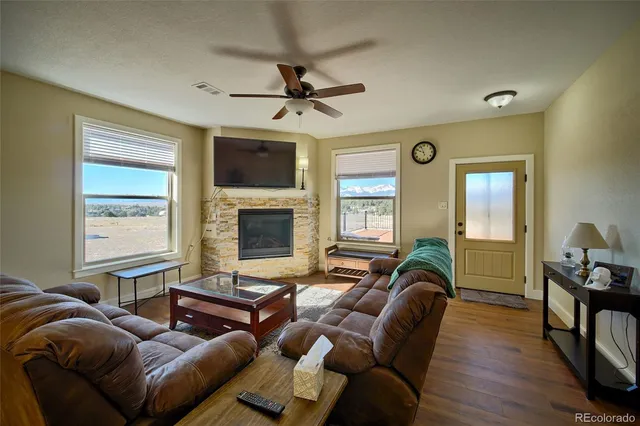 a living room with furniture fireplace and a window