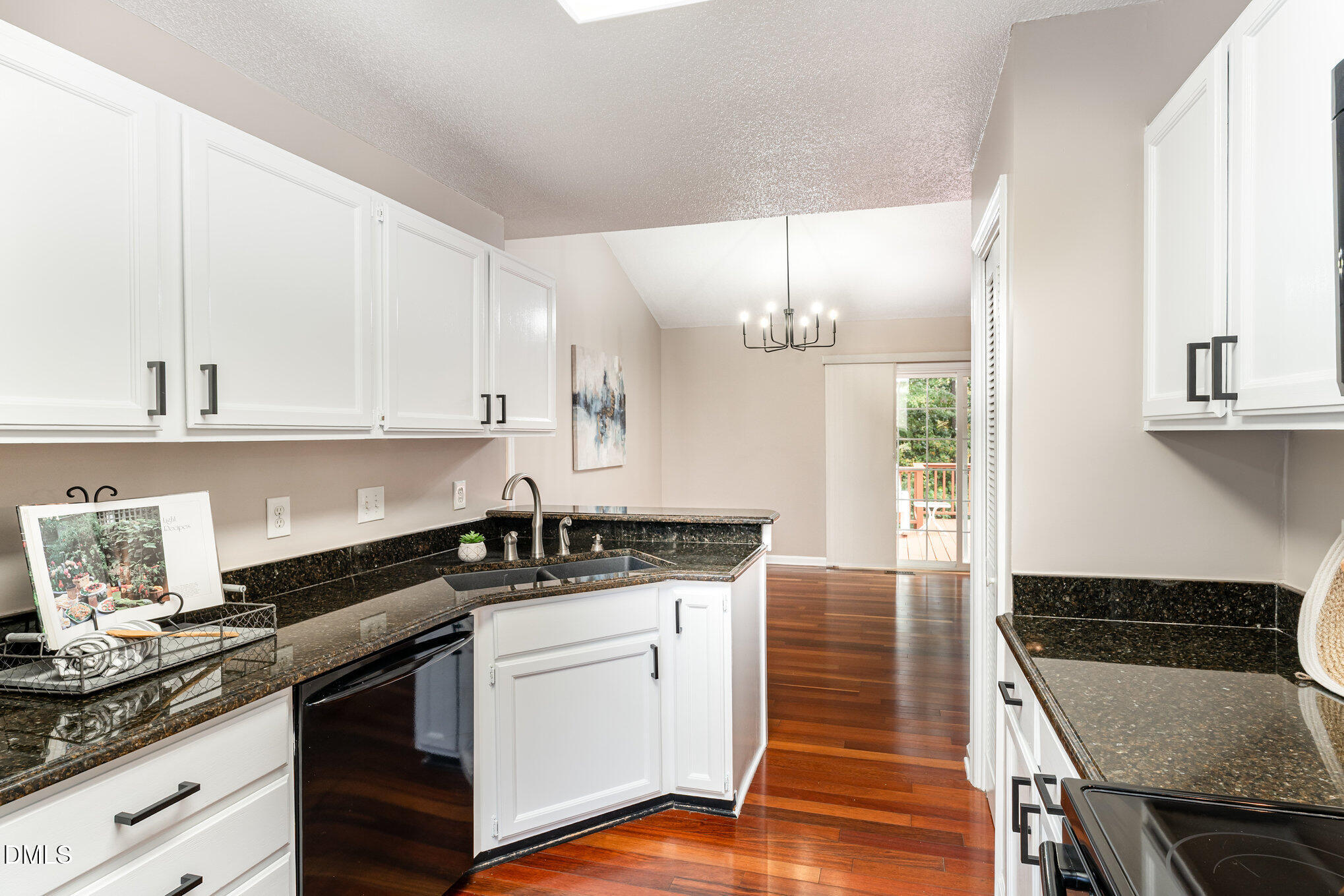 2817 Rue Sans Famille Raleigh, NC 27607 - Photo 7 of 18 a kitchen with granite countertop a stove a sink and white cabinets