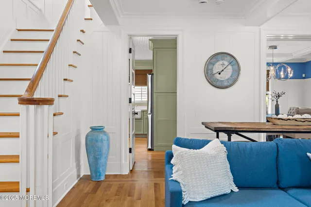 a view of a dining room with furniture wooden floor and chandelier