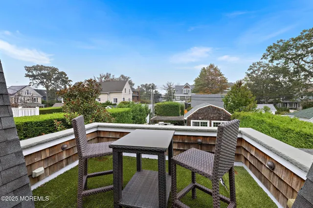 a view of a house with a big yard and potted plants