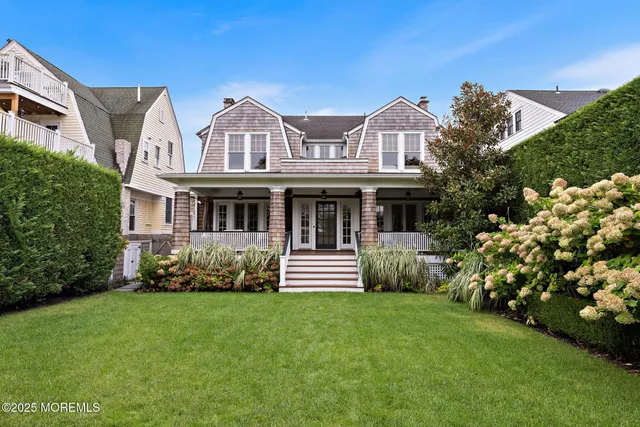 a living room with furniture a flat screen tv and a table