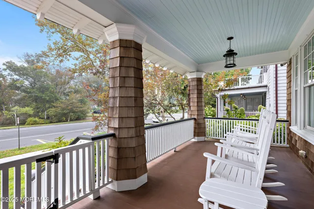 a view of a porch with furniture and a yard