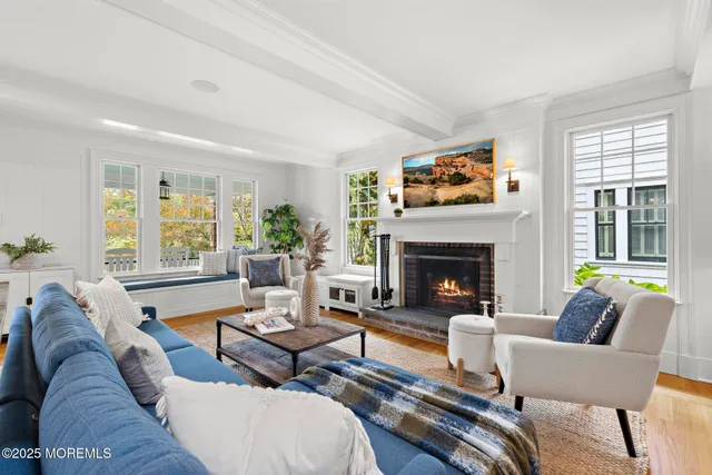a living room with furniture fireplace and a window