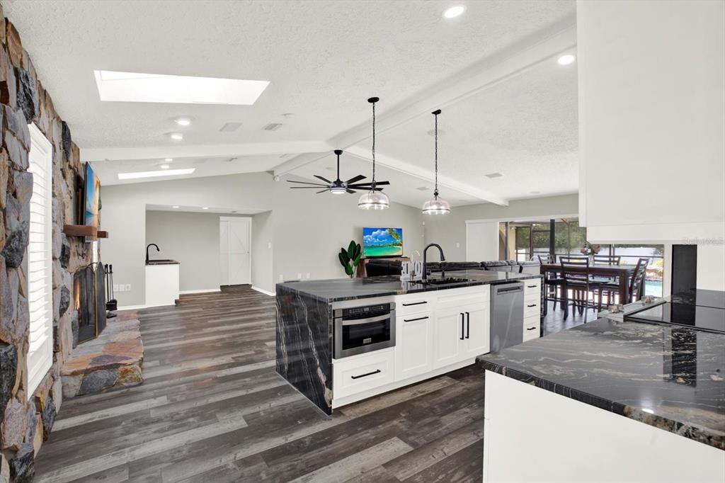 7487 River Country Drive Weeki Wachee, FL 34607 - Photo 14 of 53 a kitchen with stainless steel appliances granite countertop a stove and cabinets