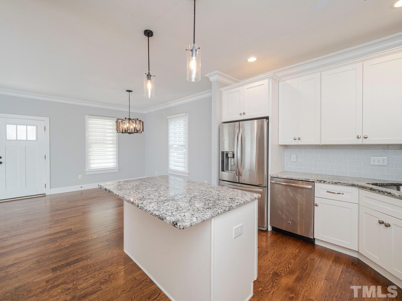 910 South Person Street Raleigh, NC 27601 - Photo 11 of 30 a kitchen with stainless steel appliances granite countertop hardwood floor sink stove and refrigerator