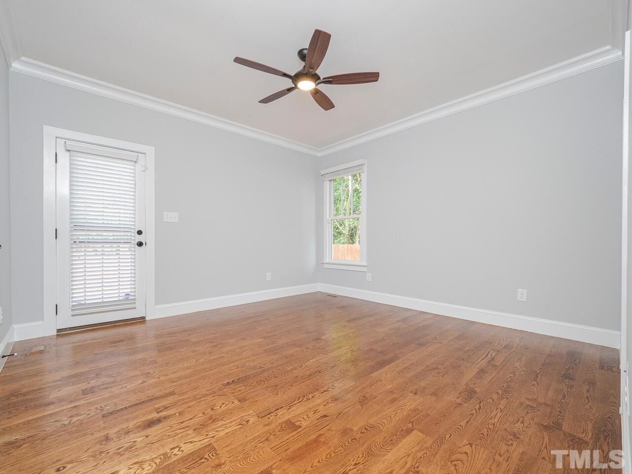 910 South Person Street Raleigh, NC 27601 - Photo 14 of 30 an empty room with wooden floor ceiling fan and windows