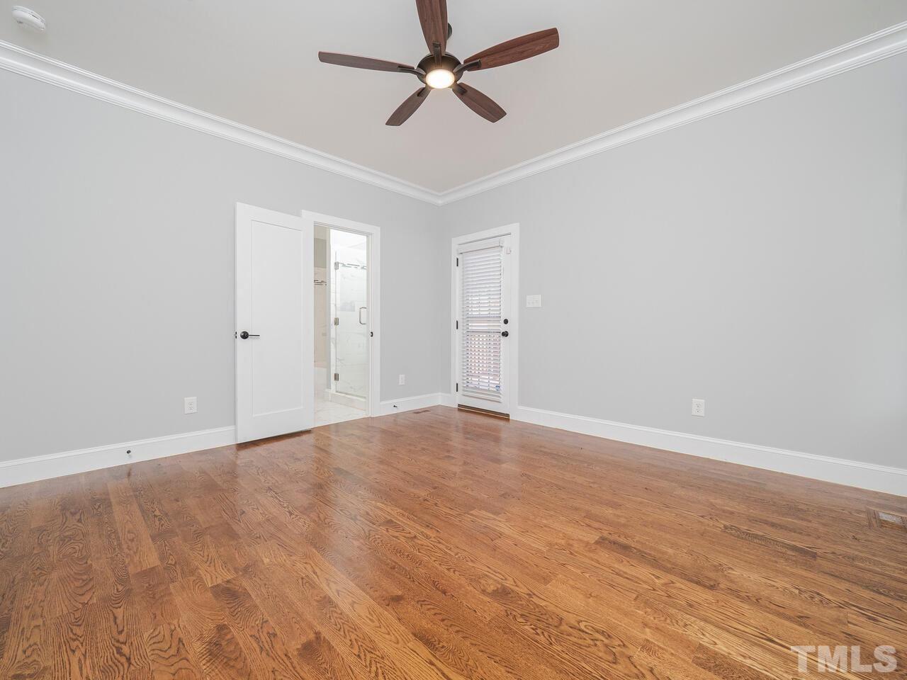 910 South Person Street Raleigh, NC 27601 - Photo 15 of 30 an empty room with wooden floor ceiling fan and windows