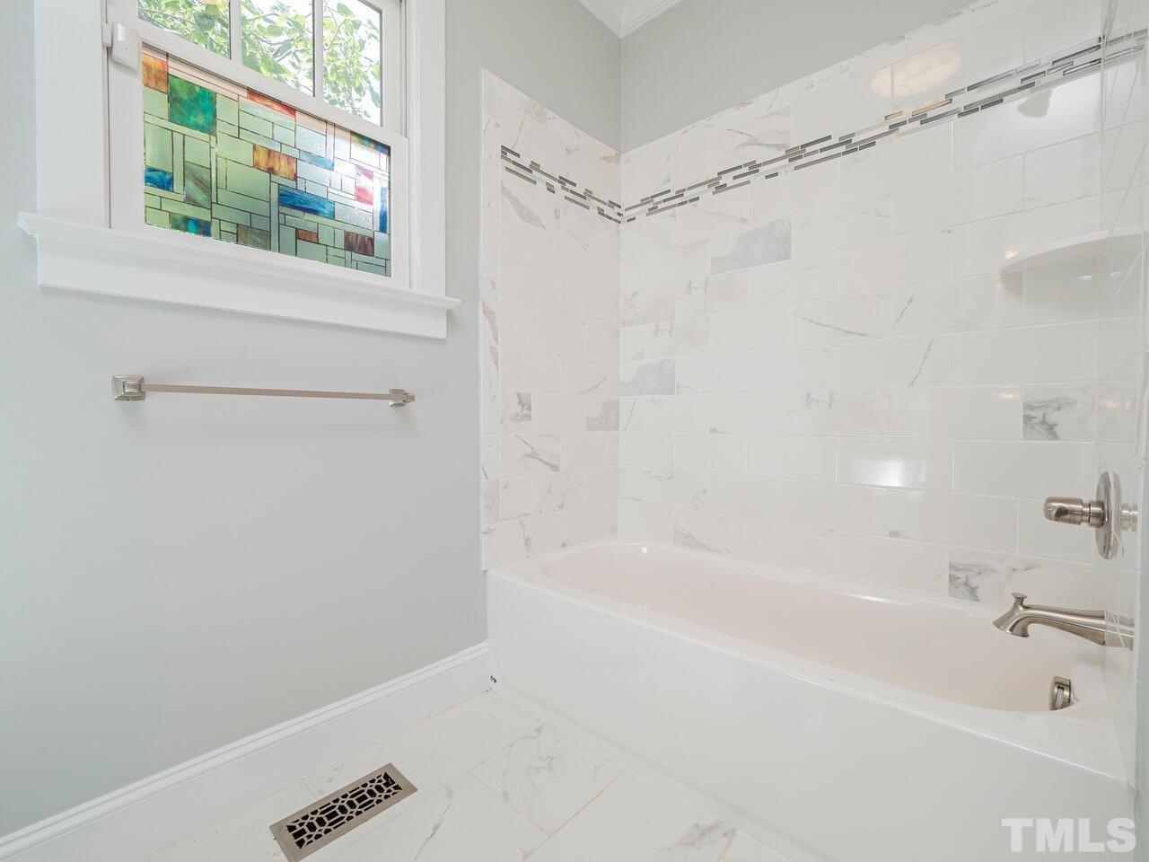 910 South Person Street Raleigh, NC 27601 - Photo 18 of 30 a bathroom with a bathtub and a shower