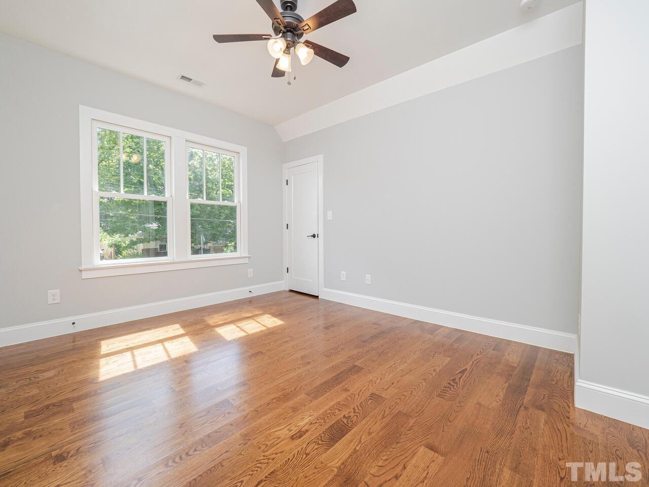 910 South Person Street Raleigh, NC 27601 - Photo 20 of 30 an empty room with wooden floor fan and windows
