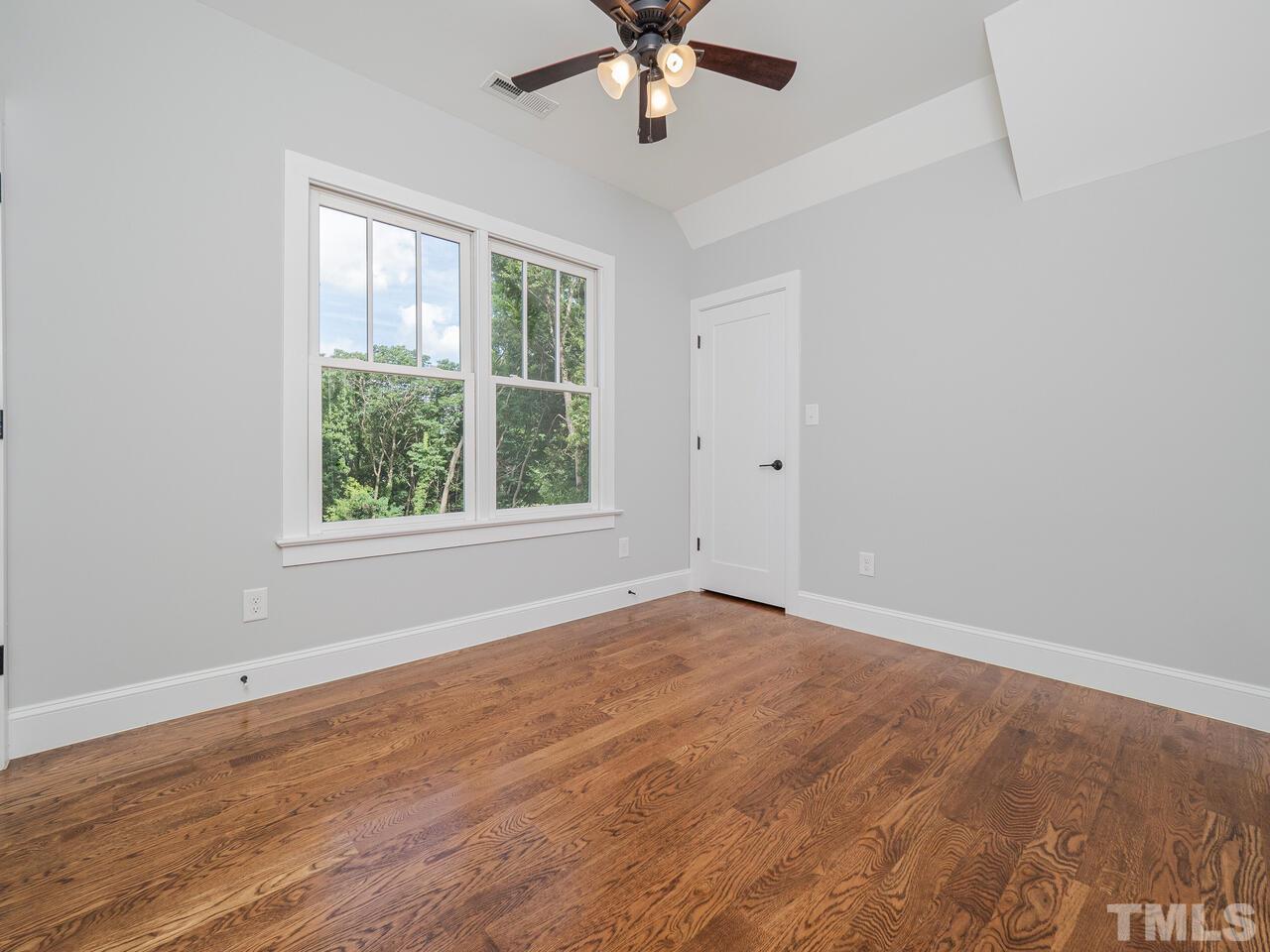 910 South Person Street Raleigh, NC 27601 - Photo 21 of 30 an empty room with a window and a ceiling fan