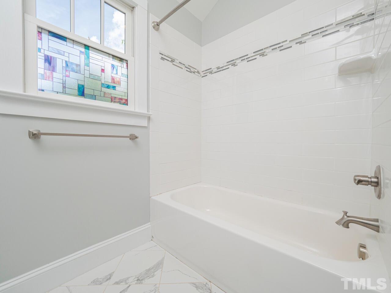910 South Person Street Raleigh, NC 27601 - Photo 23 of 30 a white bath tub with a shower