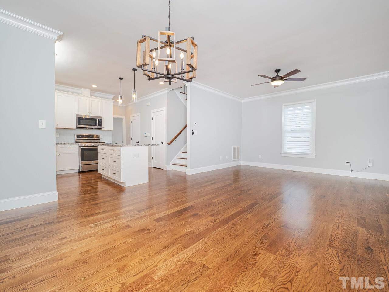 910 South Person Street Raleigh, NC 27601 - Photo 4 of 30 a view of empty room with wooden floor and ceiling fan
