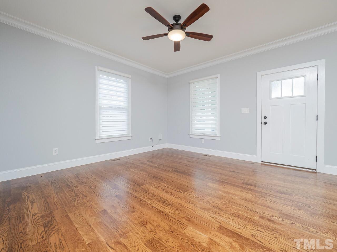 910 South Person Street Raleigh, NC 27601 - Photo 6 of 30 a view of an empty room with a window and wooden floor