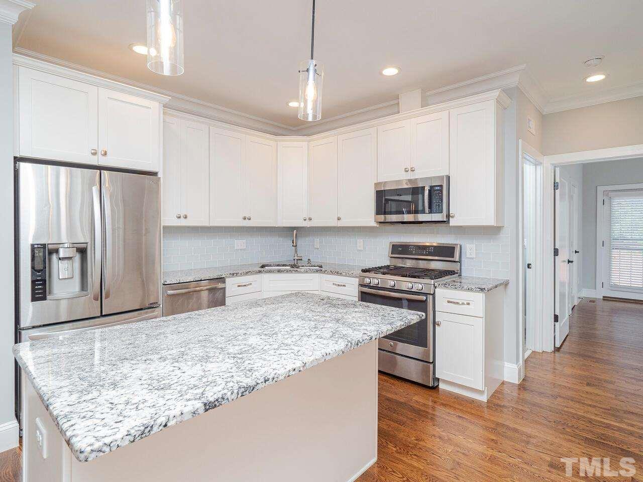 910 South Person Street Raleigh, NC 27601 - Photo 8 of 30 a kitchen with stainless steel appliances granite countertop a stove a sink and a refrigerator