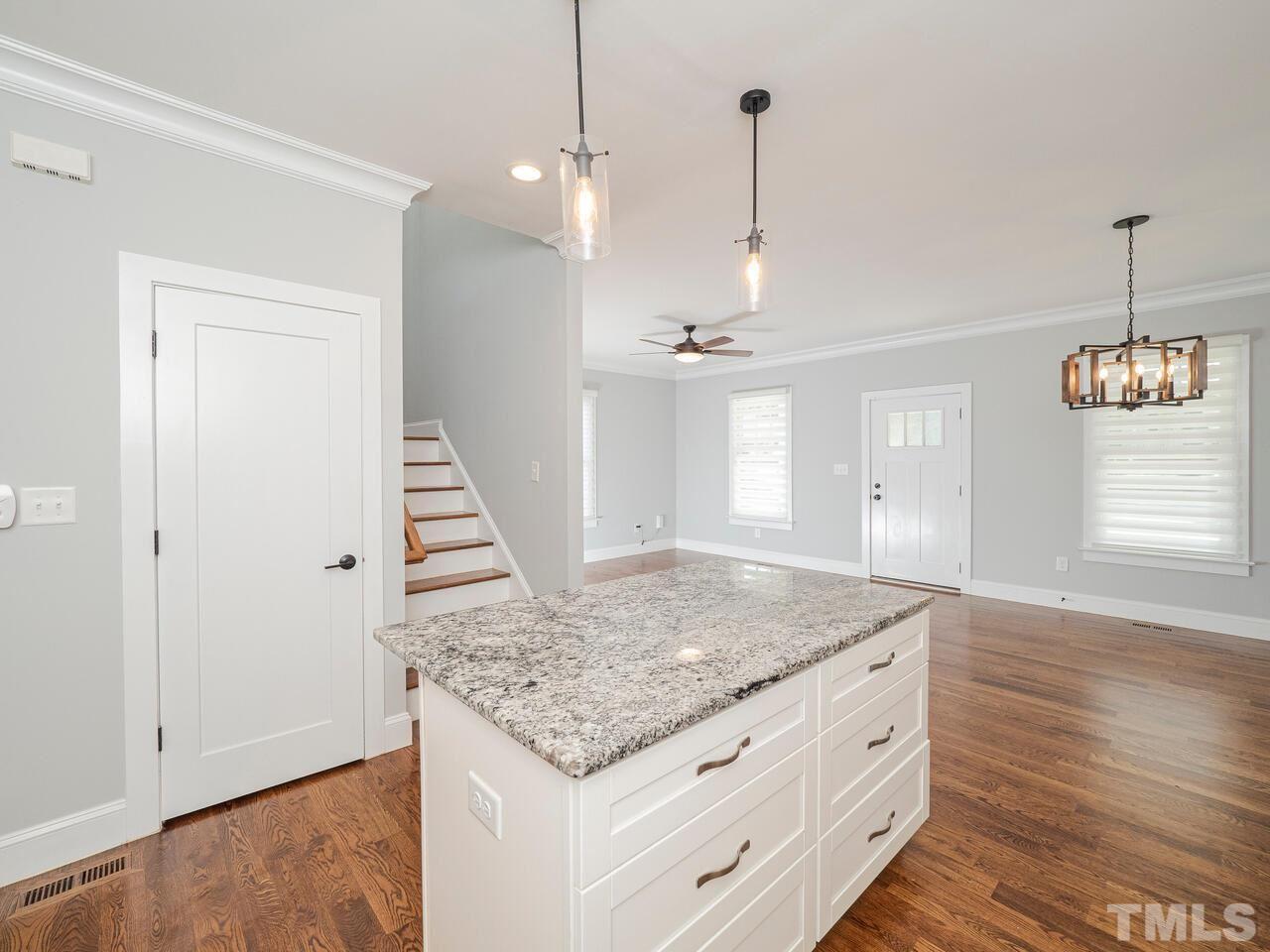 910 South Person Street Raleigh, NC 27601 - Photo 10 of 30 a view of a kitchen island wooden floor and staircase