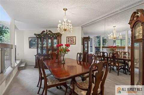 a view of a dining room with furniture and chandelier